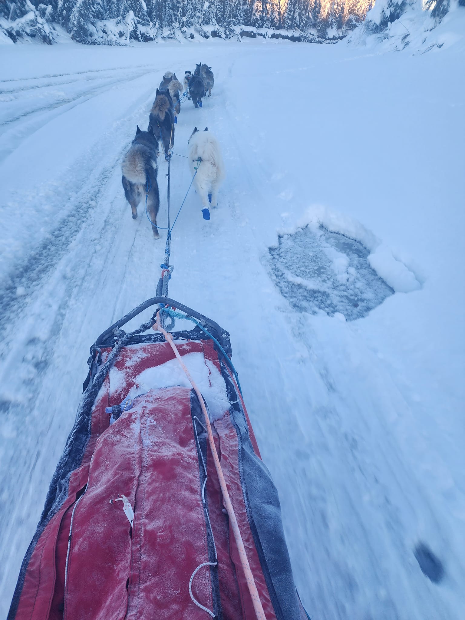 sledding over icy river